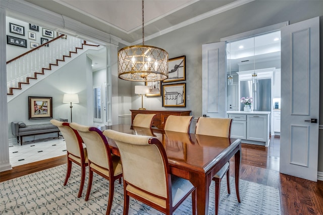 5932 Royal Palm Dr, Plano, TX 75093 - dining space with crown molding, dark wood-style flooring, a chandelier, and stairs