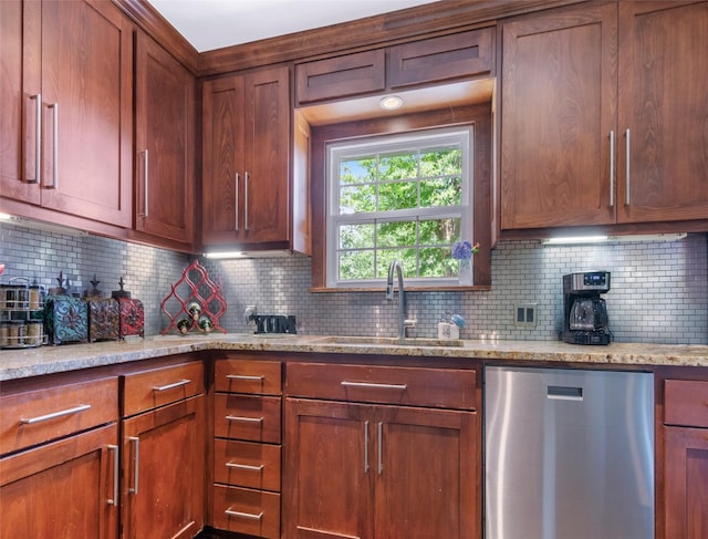 3614 Birdwell Dr, Tyler, TX 75701 - kitchen with dishwasher, a sink, backsplash, light stone counters, and brown cabinetry