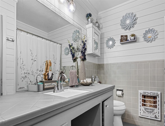 3614 Birdwell Dr, Tyler, TX 75701 - full bath with heating unit, vanity, toilet, wood walls, and a shower with curtain