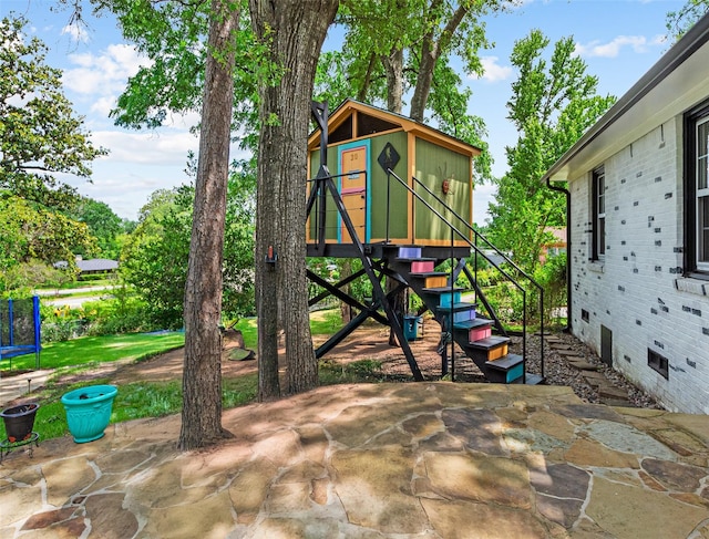 3614 Birdwell Dr, Tyler, TX 75701 - view of play area with a patio area and a trampoline