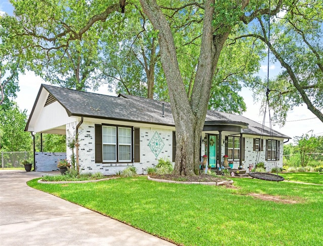 3614 Birdwell Dr, Tyler, TX 75701 - ranch-style house with driveway, an attached carport, a front yard, and brick siding