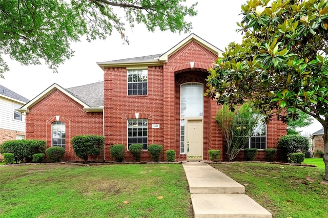 9405 Meyers Cyn, Plano, TX 75025 - traditional-style house with a front yard, brick siding, and a shingled roof