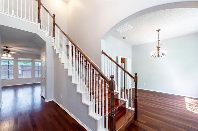 9405 Meyers Cyn, Plano, TX 75025 - staircase with wood-type flooring, ceiling fan, arched walkways, a chandelier, and baseboards