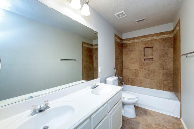 9405 Meyers Cyn, Plano, TX 75025 - bathroom featuring toilet, double vanity, shower / bathtub combination, and a textured ceiling