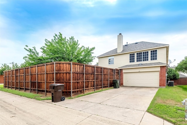 9405 Meyers Cyn, Plano, TX 75025 - rear view of property with an attached garage, central AC, concrete driveway, brick siding, and a chimney