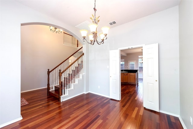 9405 Meyers Cyn, Plano, TX 75025 - unfurnished dining area with a chandelier, dark wood-type flooring, baseboards, and stairs