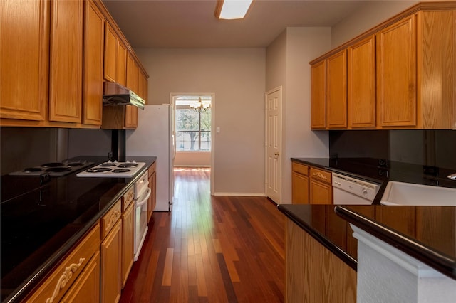 9405 Meyers Cyn, Plano, TX 75025 - kitchen with white appliances, dark countertops, dark wood-type flooring, under cabinet range hood, and a sink