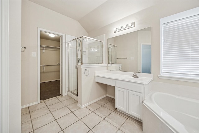 11181 Clearstream Ln, Frisco, TX 75035 - bathroom with a stall shower, a walk in closet, a bath, tile patterned floors, and a sink