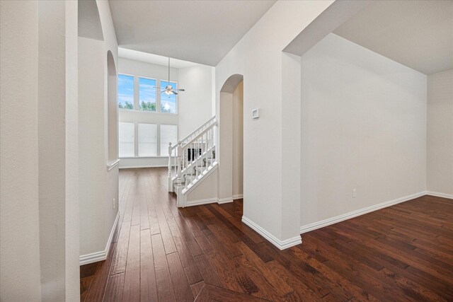 11181 Clearstream Ln, Frisco, TX 75035 - corridor featuring arched walkways, dark wood-style flooring, baseboards, and stairs