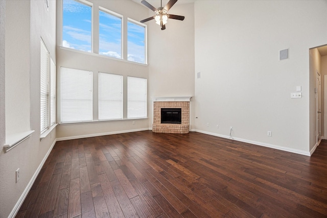 11181 Clearstream Ln, Frisco, TX 75035 - unfurnished living room featuring a towering ceiling, a ceiling fan, dark wood-style floors, baseboards, and healthy amount of natural light