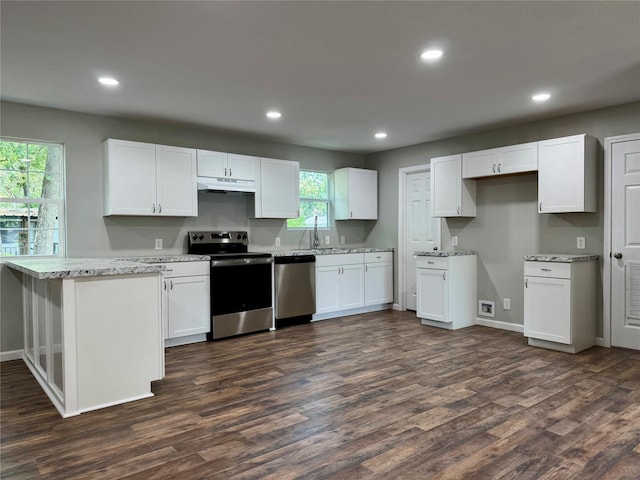 151 Pawnee Trl, Mabank, TX 75156 - kitchen with appliances with stainless steel finishes, under cabinet range hood, dark wood finished floors, recessed lighting, and white cabinets