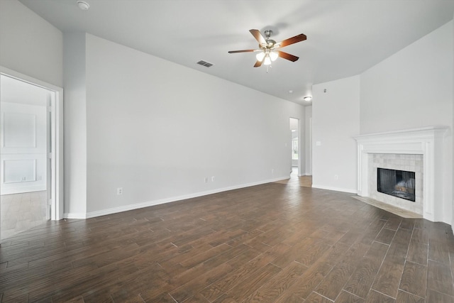 237 Cedar Crest Dr, Justin, TX 76247 - unfurnished living room featuring a ceiling fan, dark wood-style flooring, a tiled fireplace, and baseboards