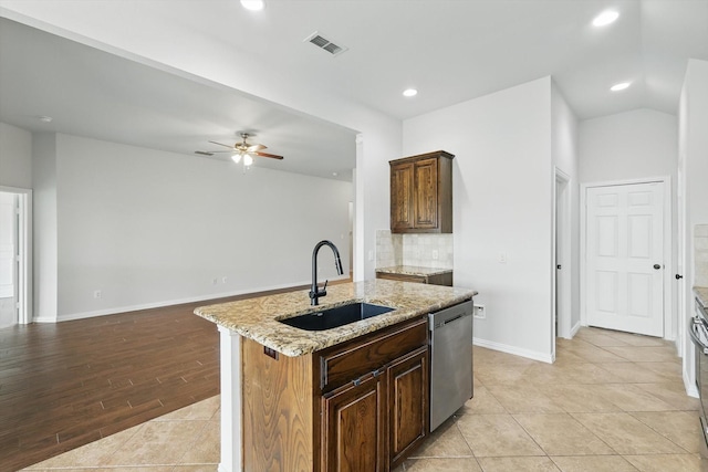 237 Cedar Crest Dr, Justin, TX 76247 - kitchen with stainless steel dishwasher, a sink, backsplash, light stone counters, and recessed lighting