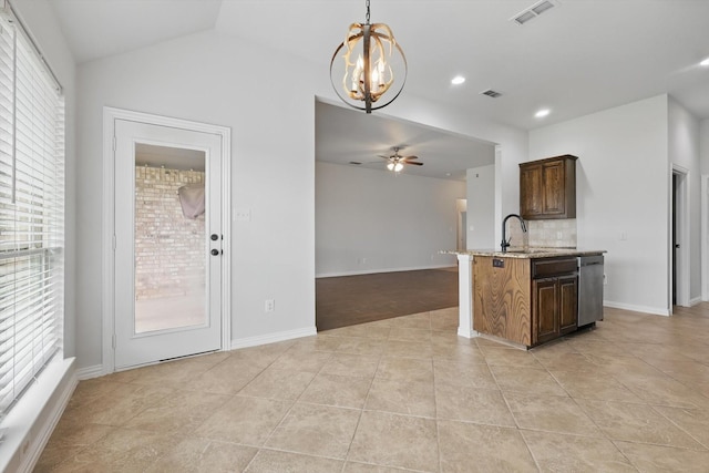 237 Cedar Crest Dr, Justin, TX 76247 - kitchen with a chandelier, a ceiling fan, light stone counters, pendant lighting, and tasteful backsplash