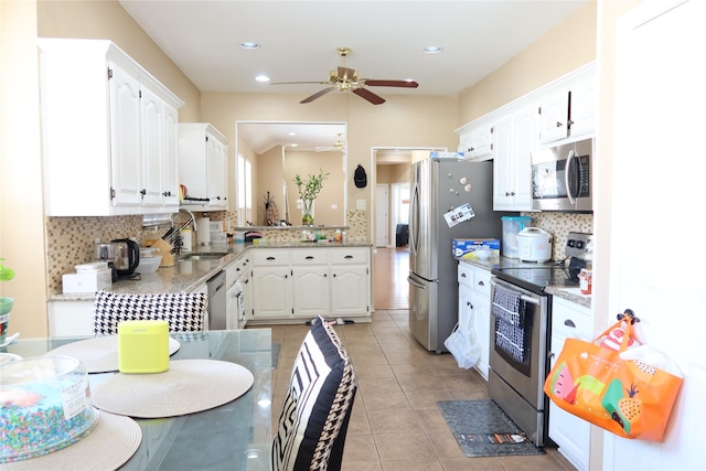 2003 Hearthside Ln, Garland, TX 75044 - kitchen with stainless steel appliances, a sink, backsplash, white cabinets, and ceiling fan