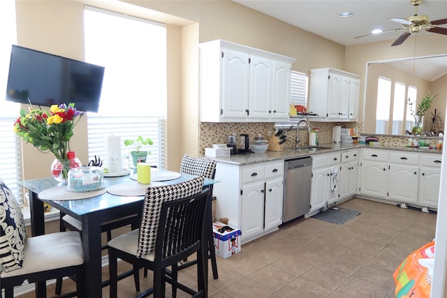 2003 Hearthside Ln, Garland, TX 75044 - kitchen with dishwasher, a sink, ceiling fan, decorative backsplash, and white cabinetry
