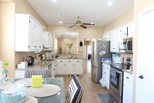 2003 Hearthside Ln, Garland, TX 75044 - kitchen with appliances with stainless steel finishes, a sink, a ceiling fan, tasteful backsplash, and recessed lighting