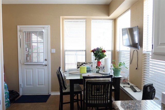 2003 Hearthside Ln, Garland, TX 75044 - dining space featuring dark tile patterned floors and baseboards
