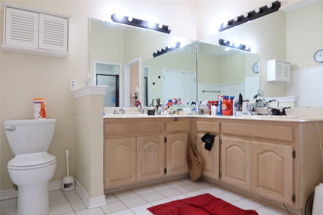 2003 Hearthside Ln, Garland, TX 75044 - bathroom featuring tile patterned flooring, toilet, double vanity, and baseboards