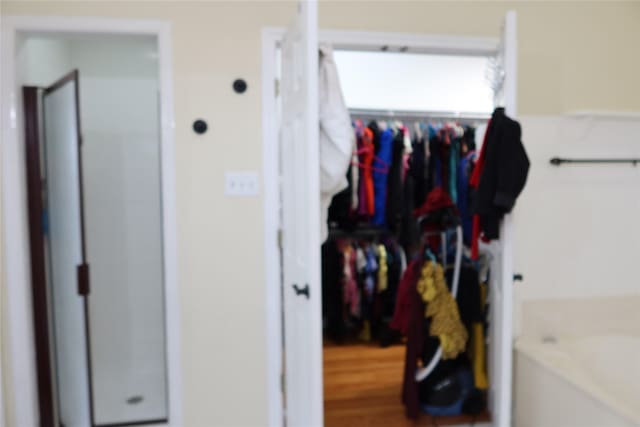 2003 Hearthside Ln, Garland, TX 75044 - full bath featuring a shower stall, a spacious closet, and a bath