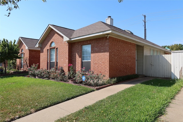 2003 Hearthside Ln, Garland, TX 75044 - view of side of home featuring brick siding and a chimney