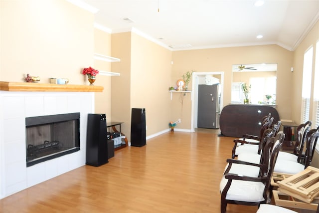 2003 Hearthside Ln, Garland, TX 75044 - living area featuring crown molding, wood finished floors, a ceiling fan, a fireplace, and recessed lighting