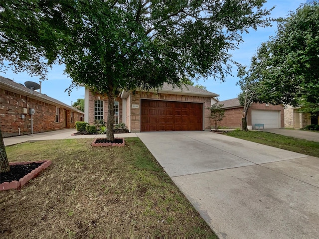 3032 Thicket Bend Ct, Fort Worth, TX 76244 - view of property hidden behind natural elements with driveway, an attached garage, and brick siding