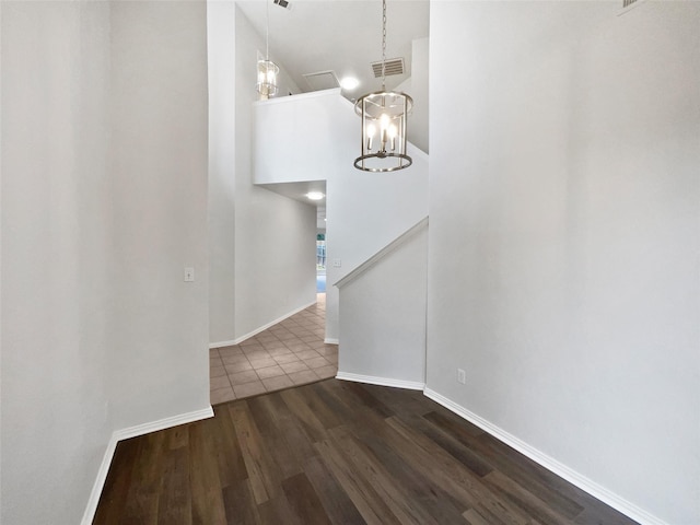 3032 Thicket Bend Ct, Fort Worth, TX 76244 - stairway featuring wood finished floors, baseboards, a chandelier, and a towering ceiling