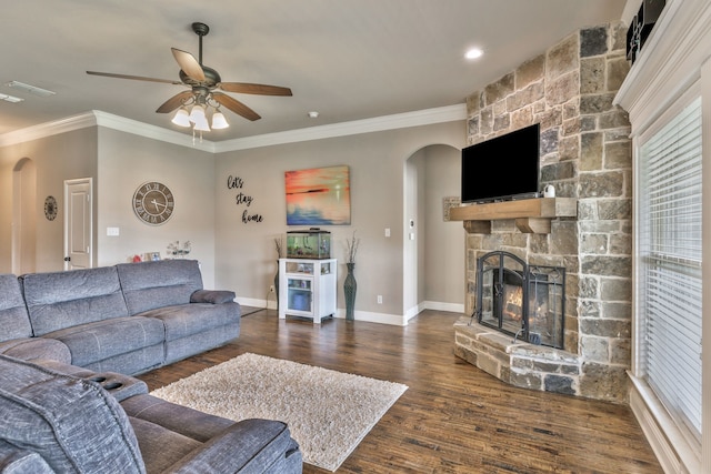 183 Melbourne Dr, Willow Park, TX 76087 - living room with arched walkways, ornamental molding, a stone fireplace, dark wood-style flooring, and a ceiling fan