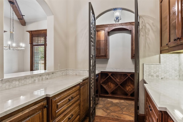 784 Cimarron Ct, Argyle, TX 76226 - wine room featuring arched walkways, a chandelier, and beam ceiling
