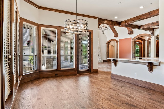 784 Cimarron Ct, Argyle, TX 76226 - unfurnished dining area featuring arched walkways, healthy amount of natural light, light wood finished floors, a chandelier, and recessed lighting