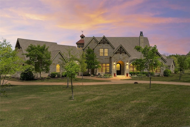 784 Cimarron Ct, Argyle, TX 76226 - french country home featuring curved driveway, stone siding, a front lawn, and a chimney