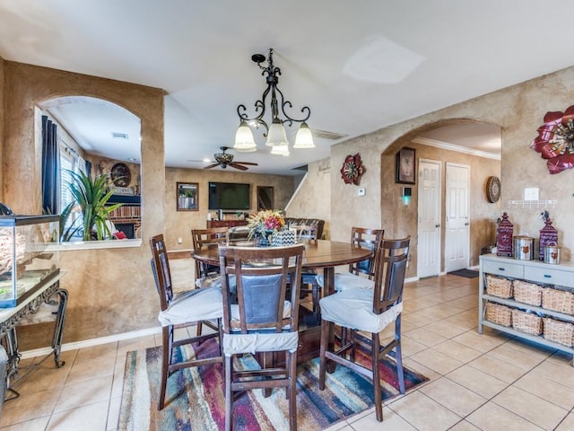 2852 Ector Dr, Grand Prairie, TX 75052 - dining area with arched walkways, light tile patterned floors, ceiling fan, and baseboards