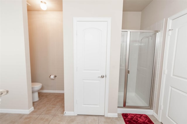 143 Valley Ranch Dr, Waxahachie, TX 75165 - bathroom with a shower stall, toilet, tile patterned flooring, and baseboards