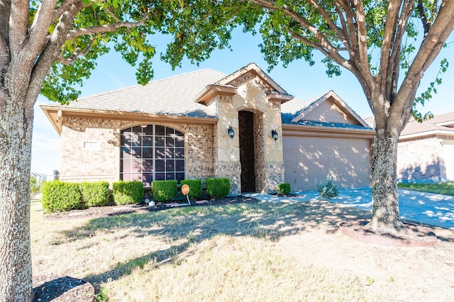 143 Valley Ranch Dr, Waxahachie, TX 75165 - view of front of house featuring a garage, driveway, brick siding, and a shingled roof