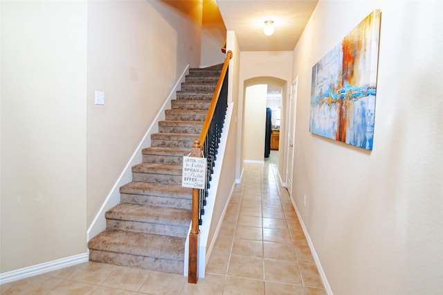 143 Valley Ranch Dr, Waxahachie, TX 75165 - stairs featuring arched walkways, tile patterned flooring, and baseboards