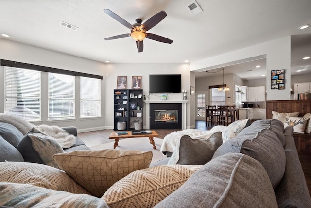 1817 Meadow Ridge Dr, Flower Mound, TX 75028 - living area featuring wood finished floors, ceiling fan, baseboards, recessed lighting, and a glass covered fireplace