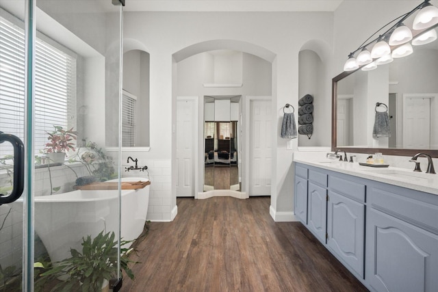 1817 Meadow Ridge Dr, Flower Mound, TX 75028 - full bathroom featuring wood finished floors, double vanity, and a freestanding bath