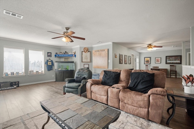 1817 Meadow Ridge Dr, Flower Mound, TX 75028 - living room featuring a ceiling fan, a textured ceiling, wood finished floors, baseboards, and ornamental molding