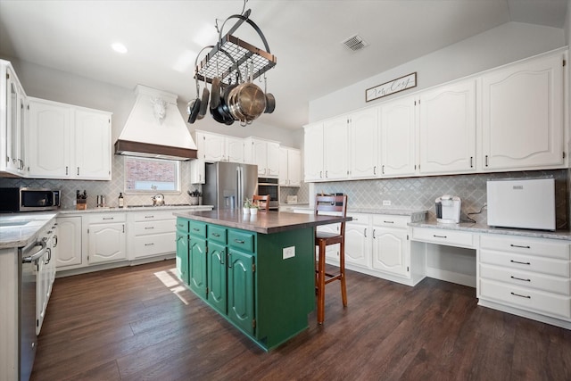 1817 Meadow Ridge Dr, Flower Mound, TX 75028 - kitchen with stainless steel appliances, premium range hood, white cabinetry, decorative backsplash, and recessed lighting