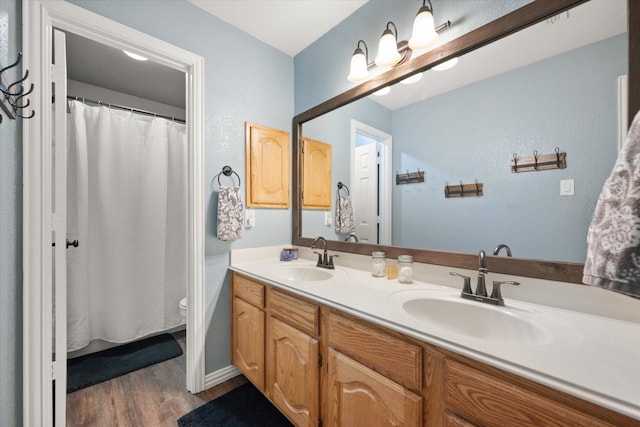 1817 Meadow Ridge Dr, Flower Mound, TX 75028 - full bath with double vanity, wood finished floors, toilet, and baseboards