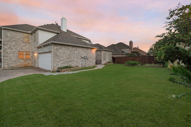 1817 Meadow Ridge Dr, Flower Mound, TX 75028 - back of house at dusk with concrete driveway, a chimney, roof with shingles, a garage, and brick siding