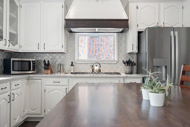 1817 Meadow Ridge Dr, Flower Mound, TX 75028 - kitchen with appliances with stainless steel finishes, exhaust hood, and white cabinets