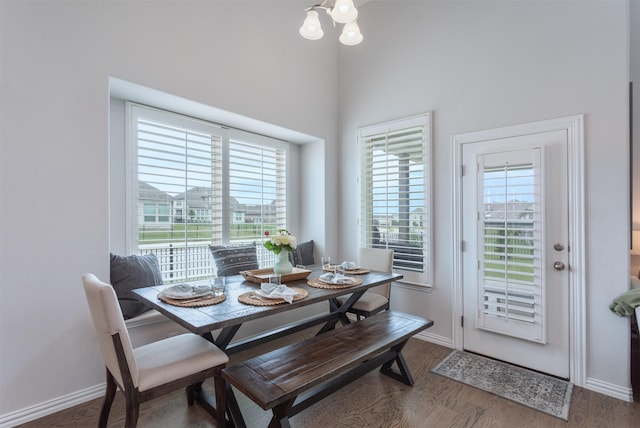 2536 Governors Blvd, Heath, TX 75126 - dining area featuring baseboards, wood finished floors, a chandelier, and a towering ceiling