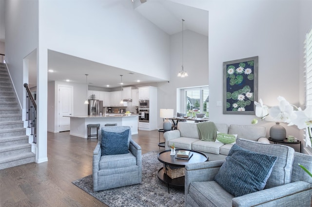2536 Governors Blvd, Heath, TX 75126 - living room with high vaulted ceiling, stairs, dark wood-style flooring, recessed lighting, and a chandelier