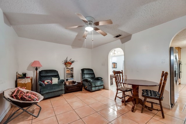 5310 Ranchero Ln, Dallas, TX 75236 - dining space with arched walkways, a textured ceiling, light tile patterned floors, and ceiling fan