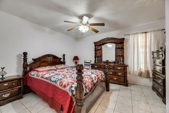 5310 Ranchero Ln, Dallas, TX 75236 - bedroom featuring light tile patterned floors, a textured ceiling, and ceiling fan
