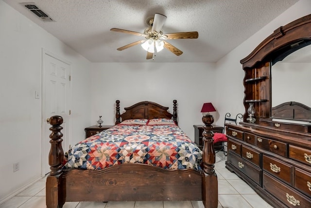 5310 Ranchero Ln, Dallas, TX 75236 - bedroom featuring light tile patterned floors, a textured ceiling, and a ceiling fan