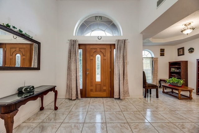 5310 Ranchero Ln, Dallas, TX 75236 - entrance foyer featuring a high ceiling, light marble finish flooring, and baseboards