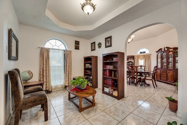 5310 Ranchero Ln, Dallas, TX 75236 - sitting room with arched walkways, a textured ceiling, and a tray ceiling